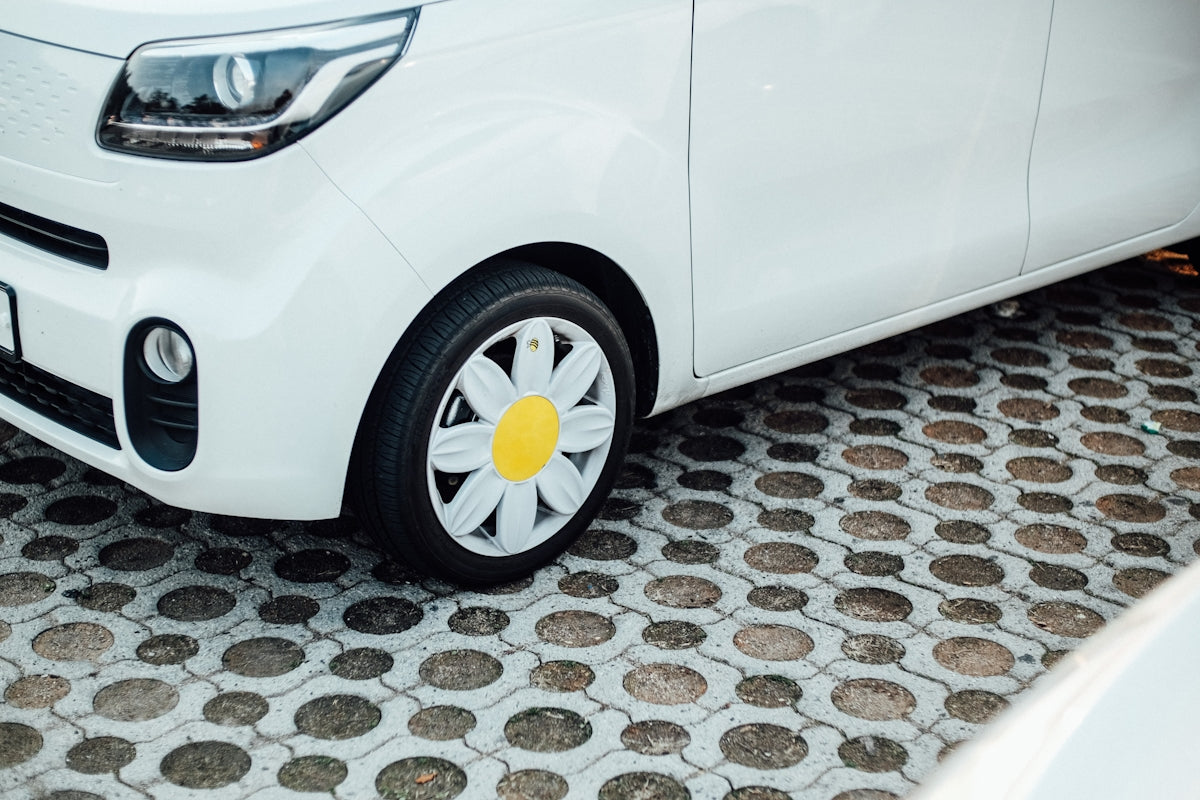 white car with flower hubcap