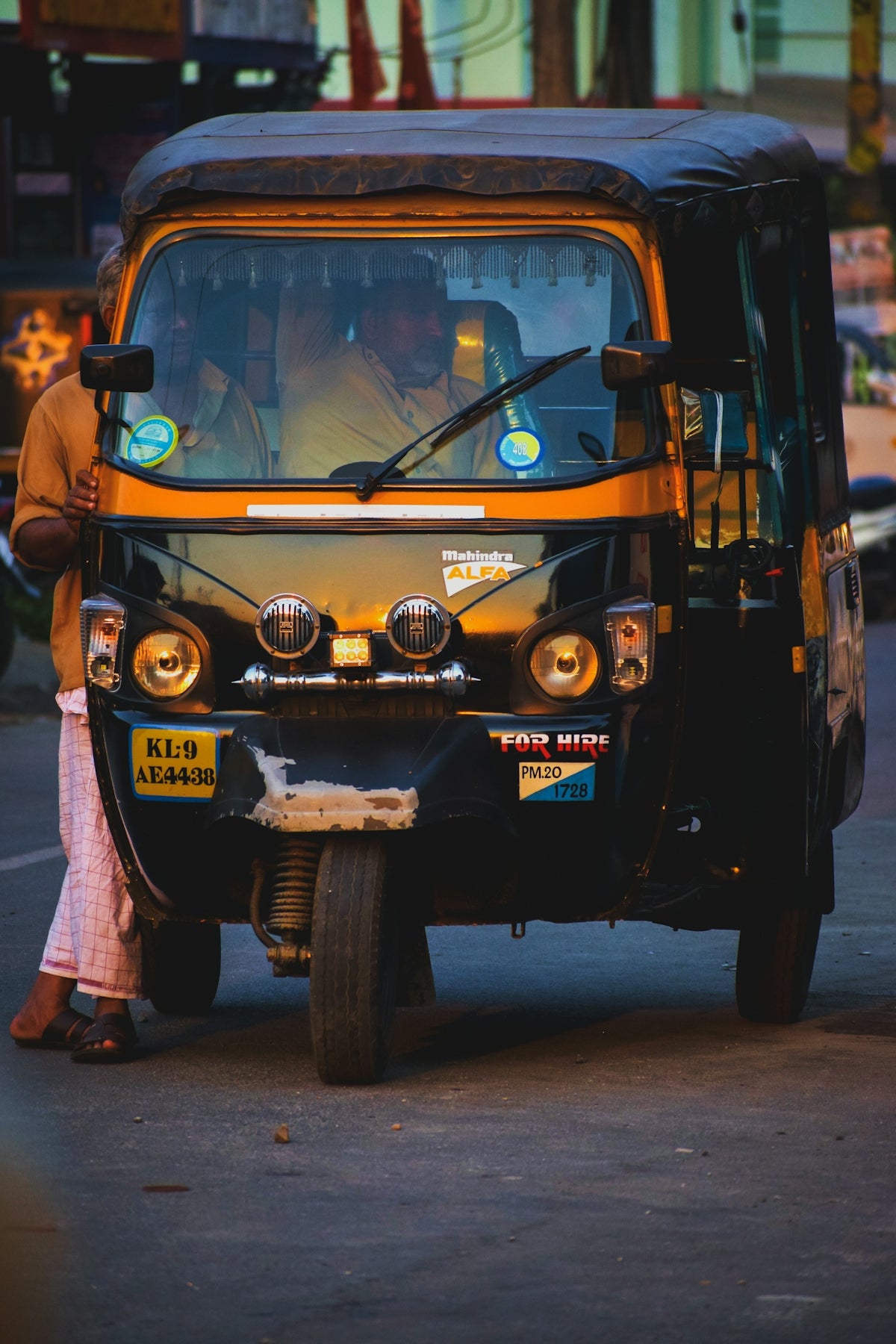 black and yellow auto rickshaw