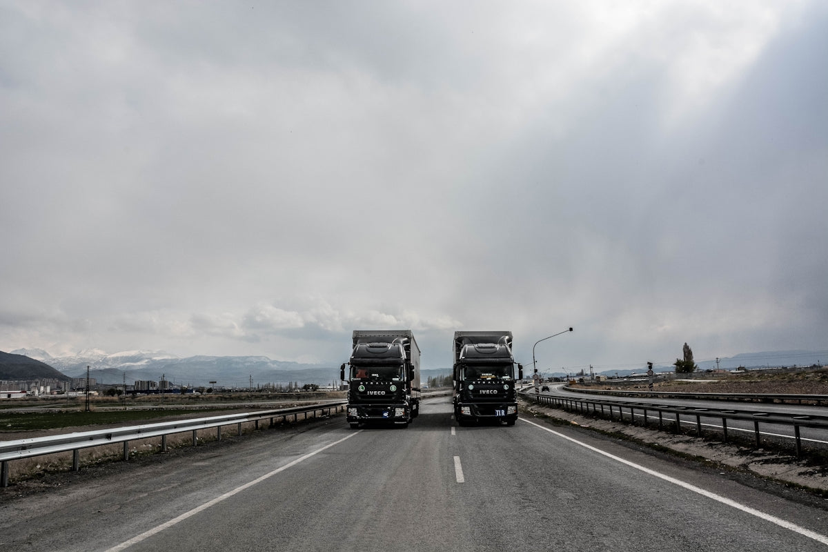 blue and white truck on road during daytime
