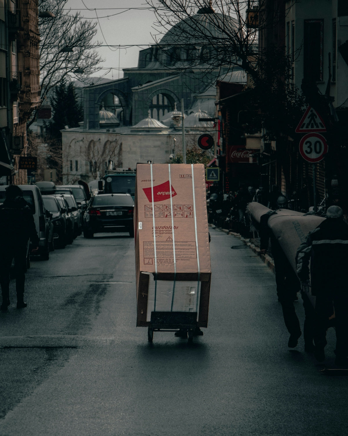 red and white box on road during daytime