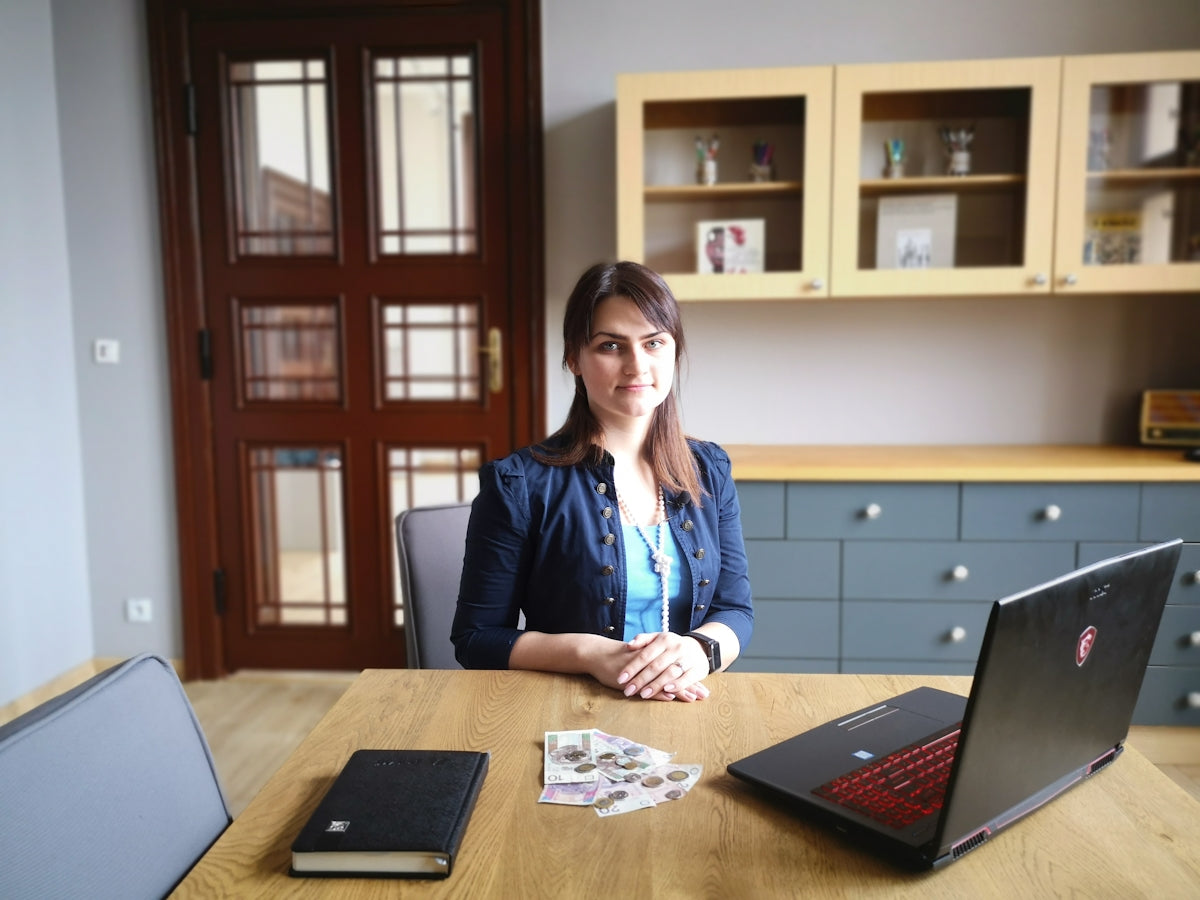 woman in black blazer sitting at the table