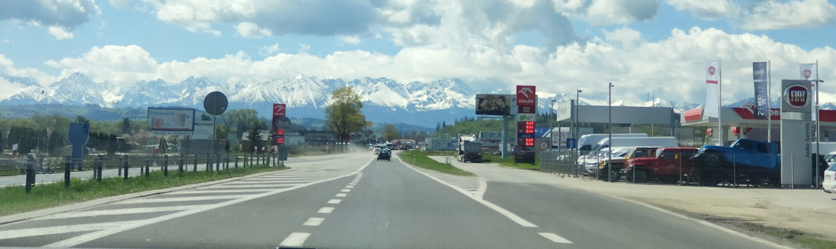 a car driving down a street next to a traffic light