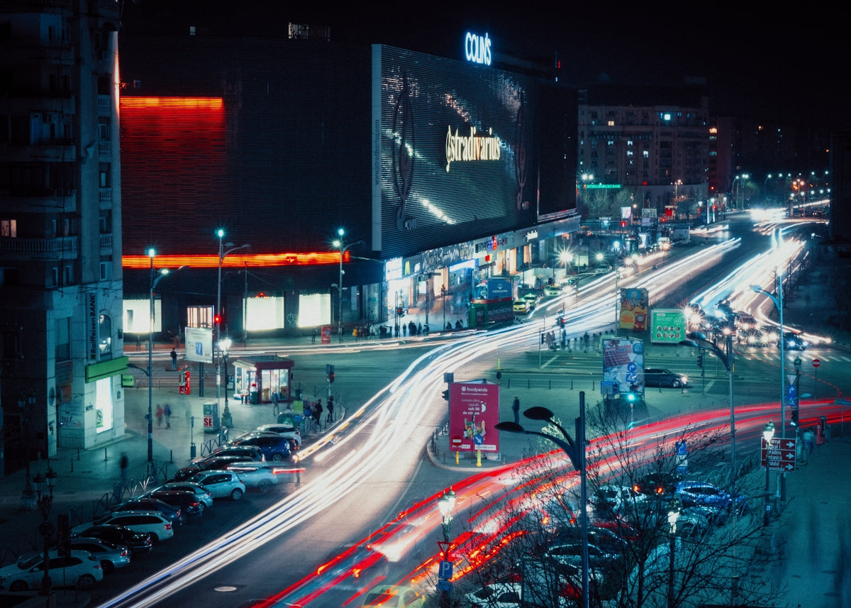 a city street filled with lots of traffic at night