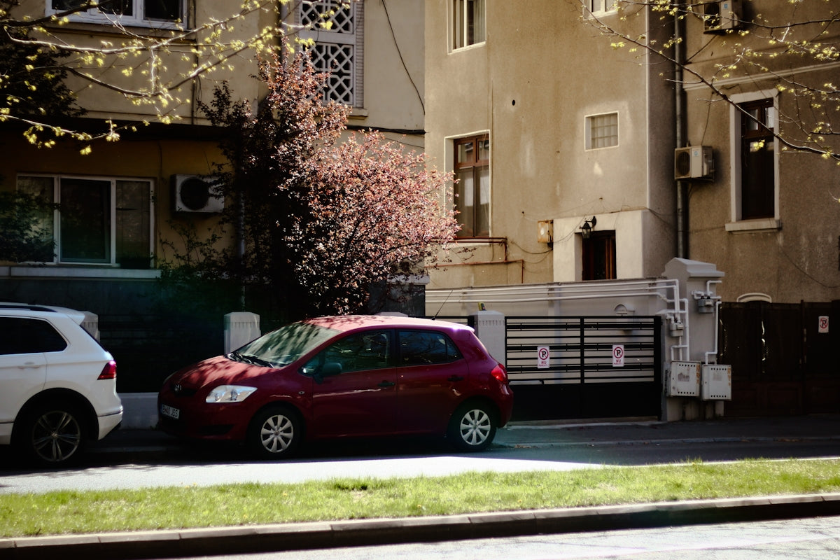 a red car parked on the side of a road