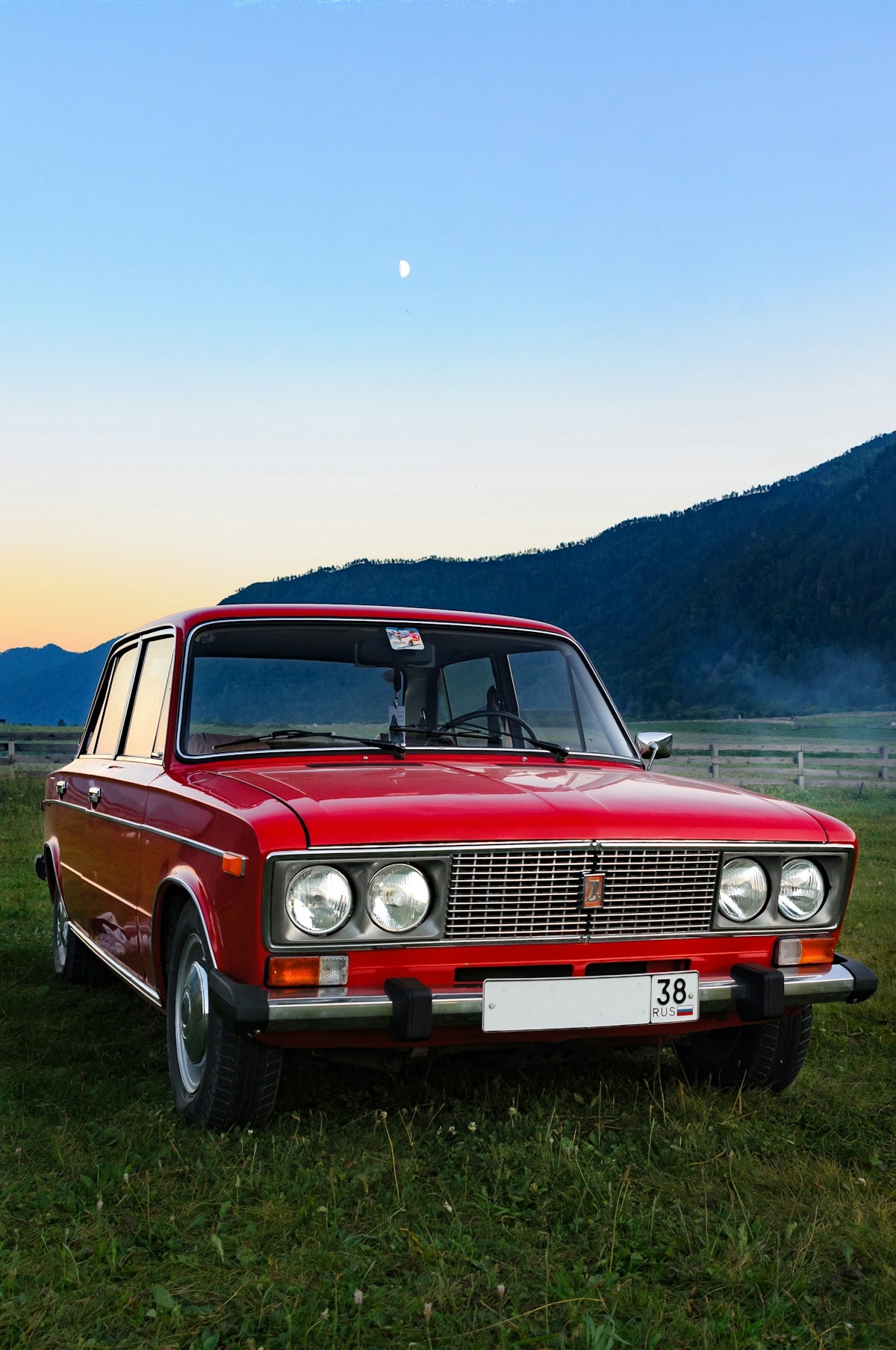 a red car parked in a field