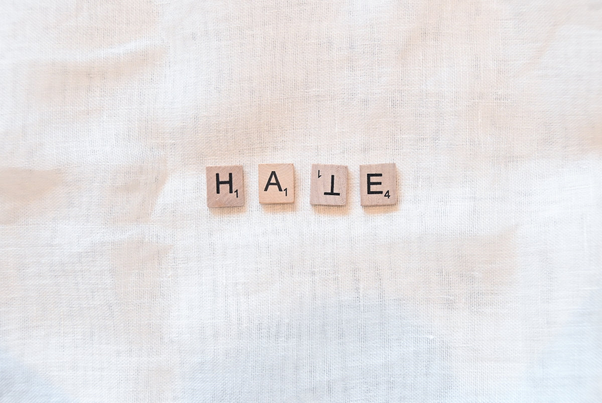 the word hale spelled with scrabble letters on a linen background