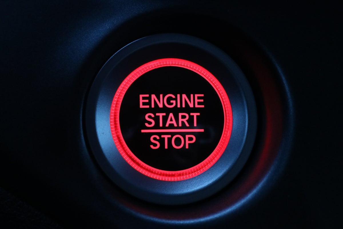a close up of a button on a car engine