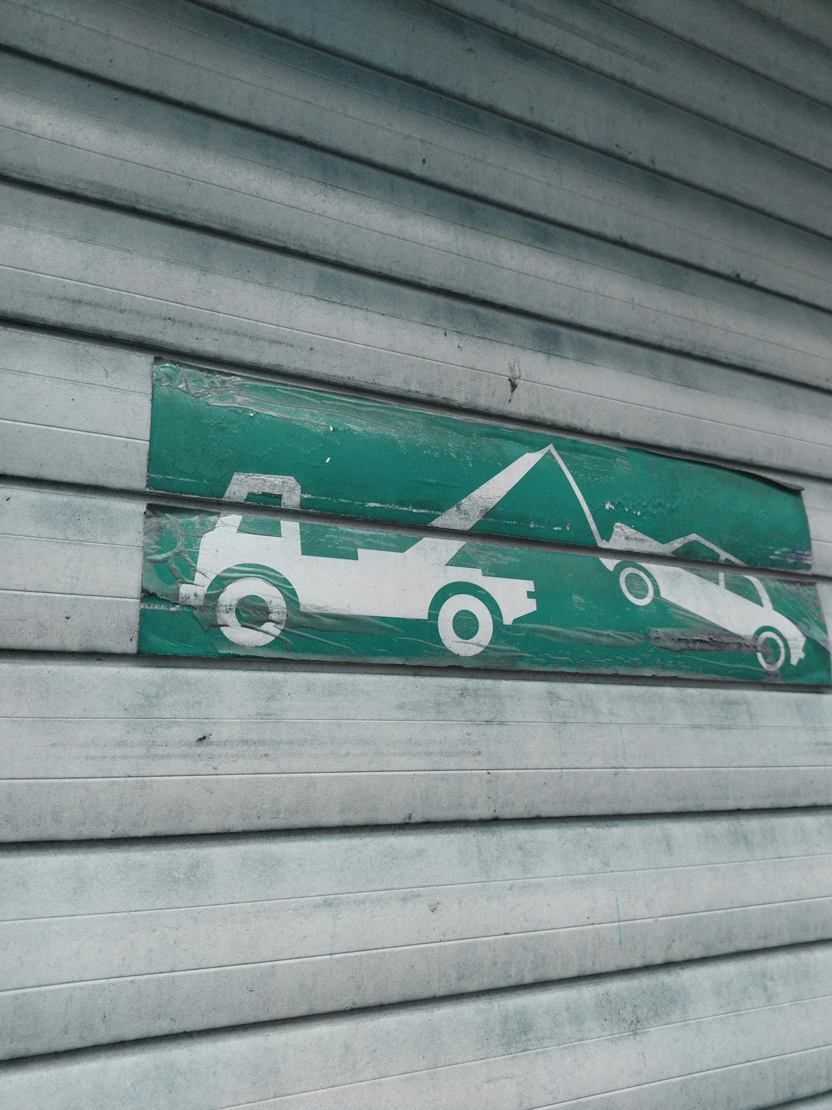 a green and white sign on the side of a building