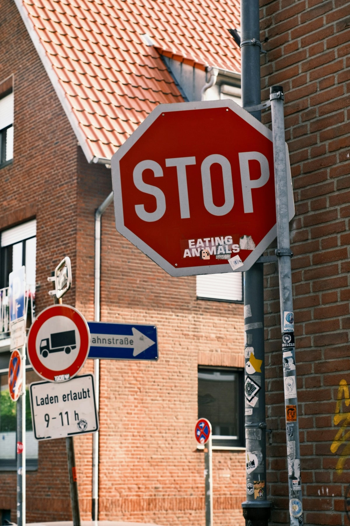 a red stop sign sitting on the side of a road