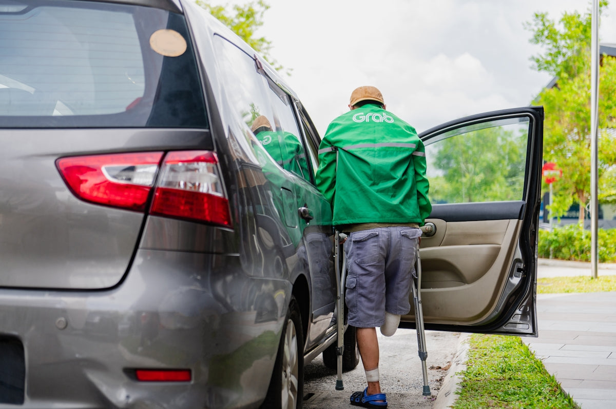 a man in a green jacket getting out of a car
