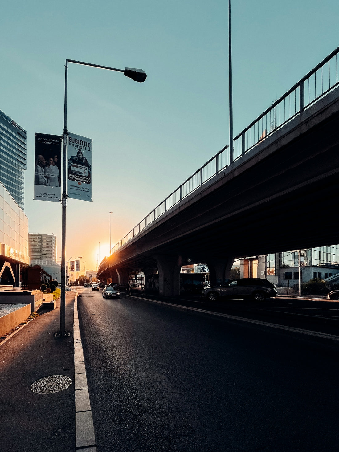 a city street with a bridge and cars on it