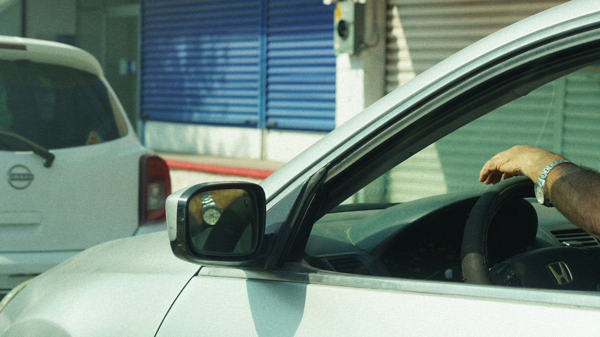 A man driving a car down a street