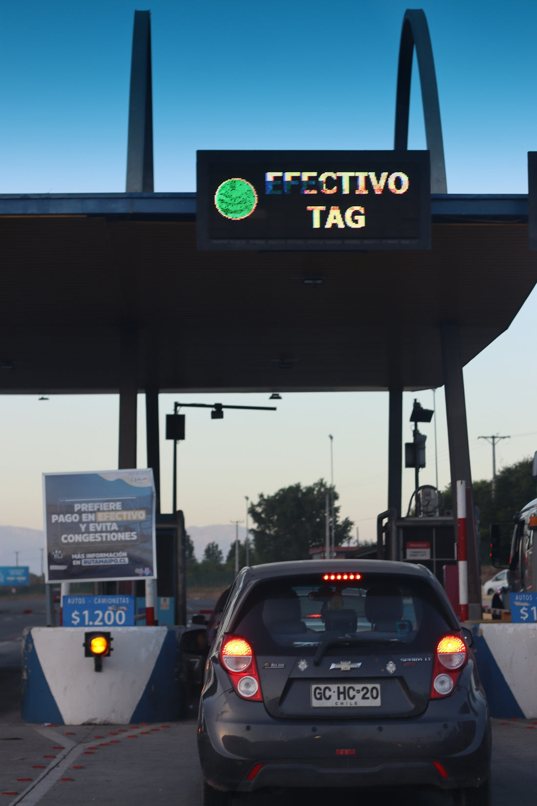 A car approaches a toll booth.