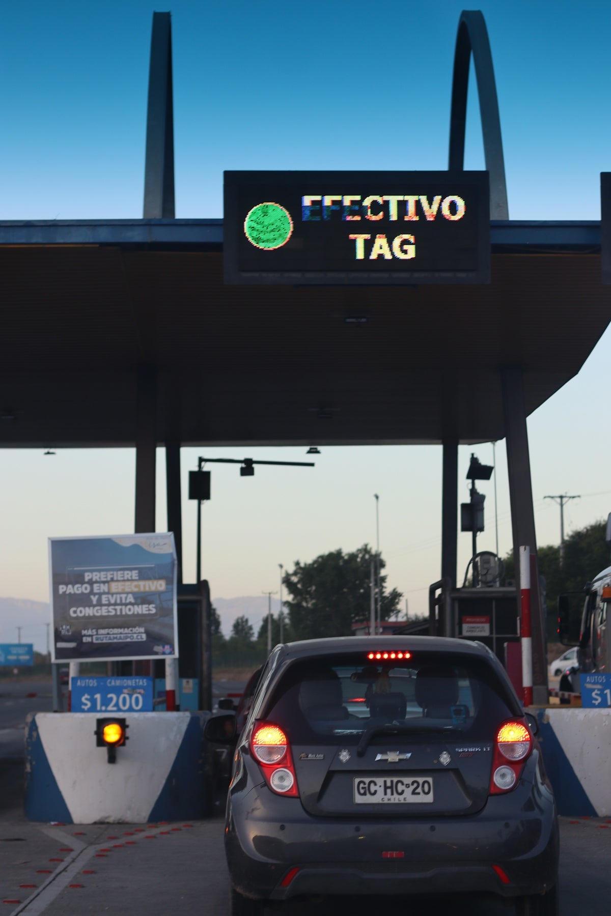 A car approaches a toll booth.