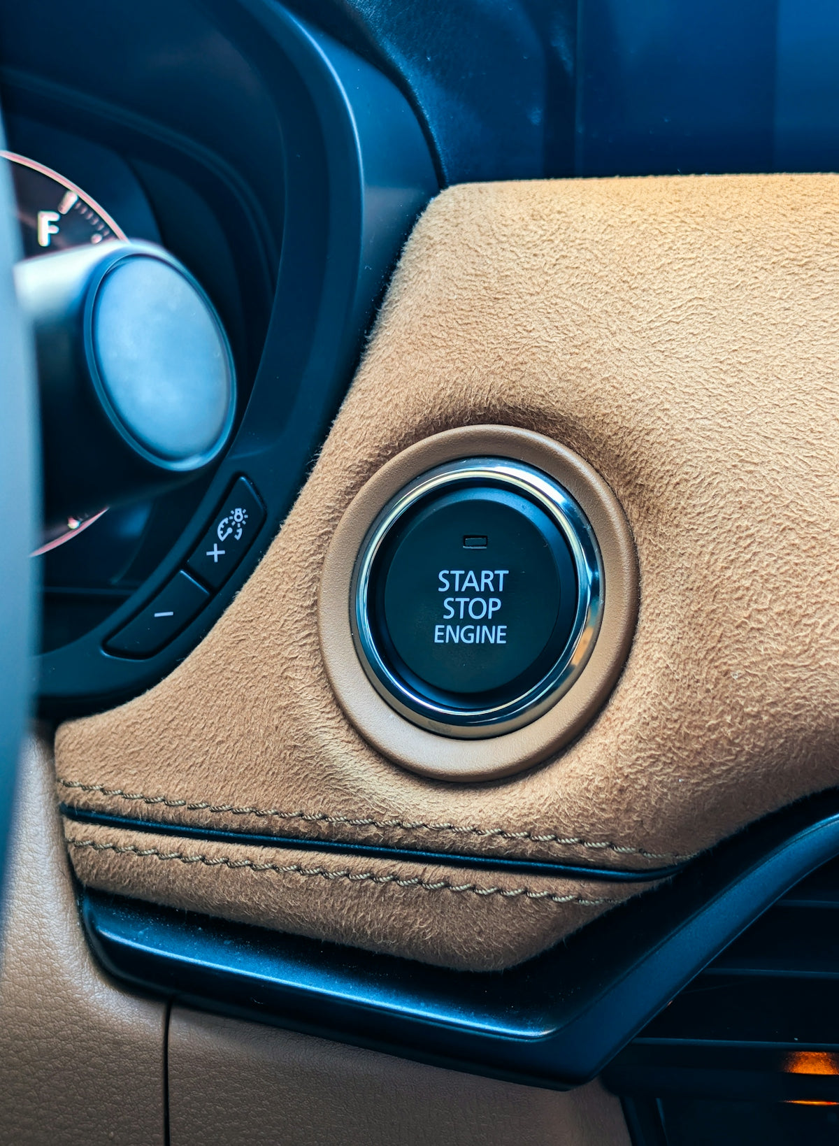 Car's start stop engine button with suede trim
