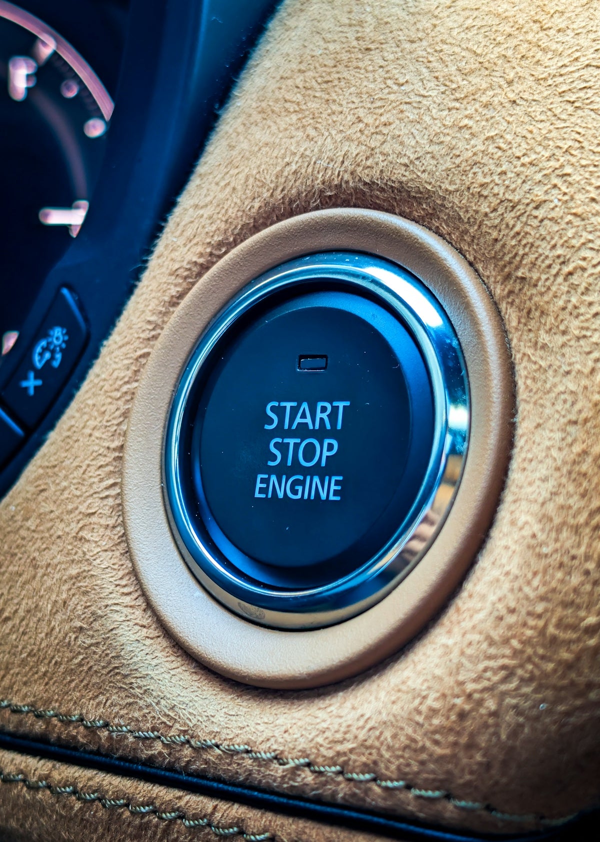 Car's start stop engine button on dashboard