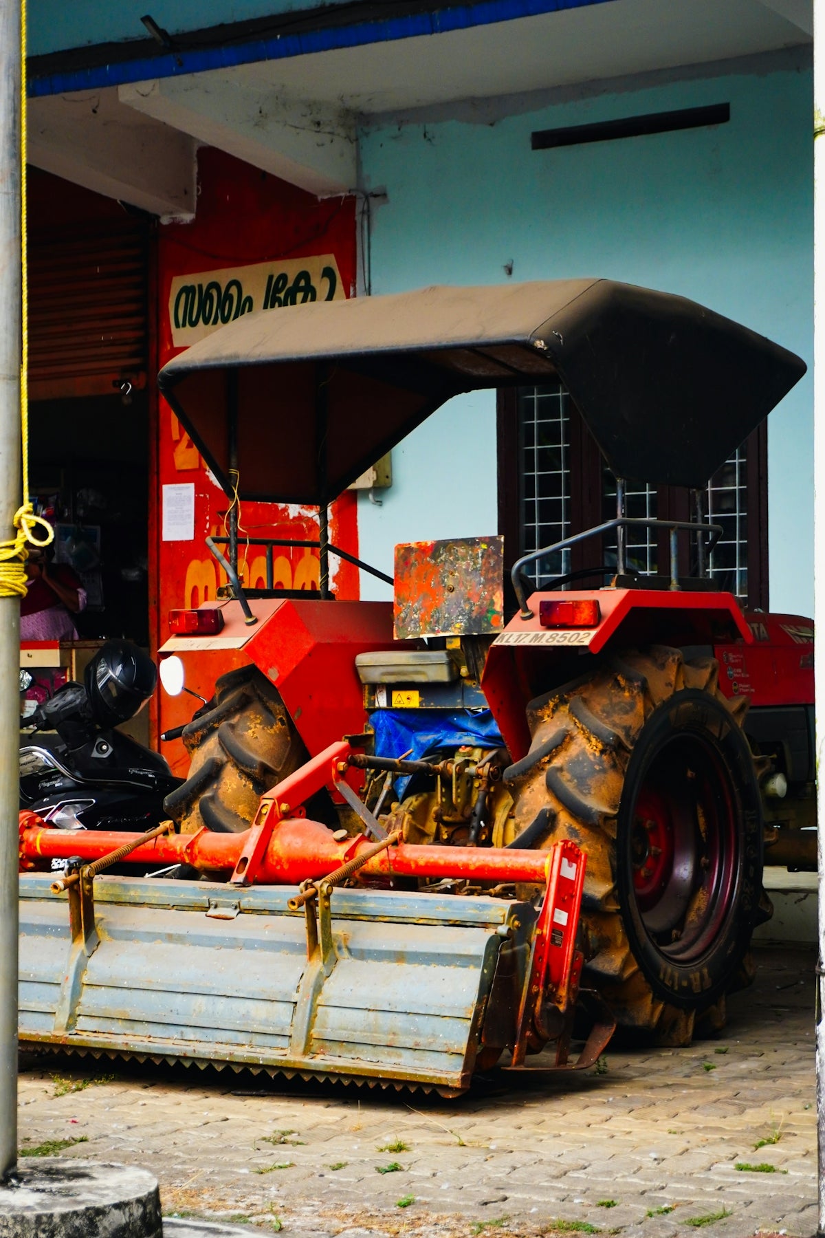A red tractor with a canopy parked canopy.