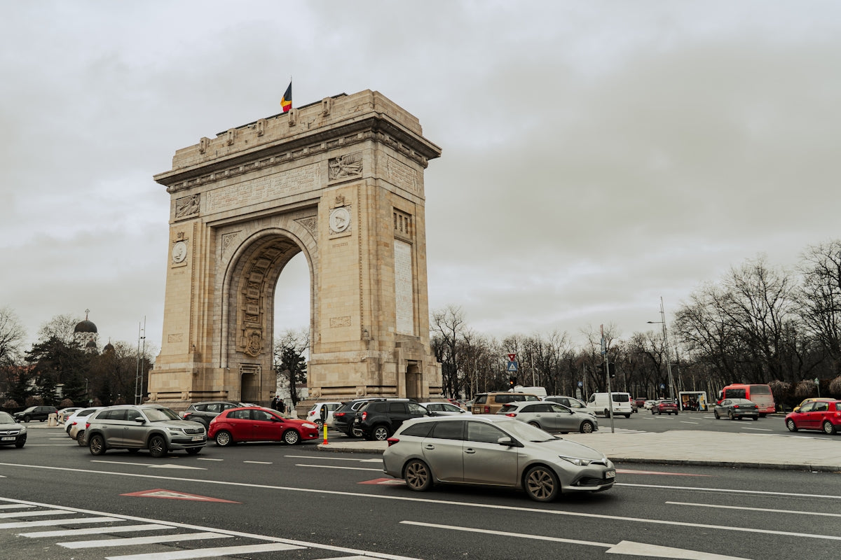 Triumphal arch monument with cars on a street