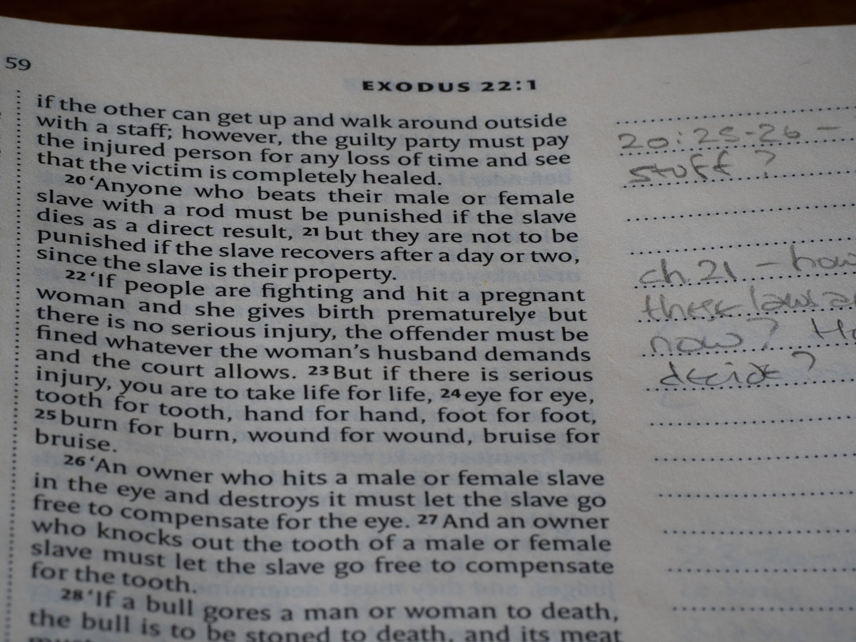 Close-up of an open bible with handwritten notes.