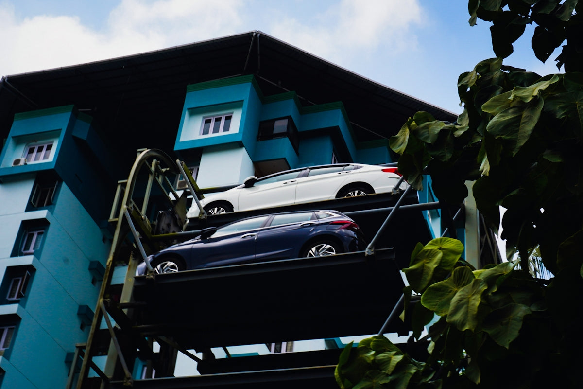 Two cars parked on a multi-level automated parking system.