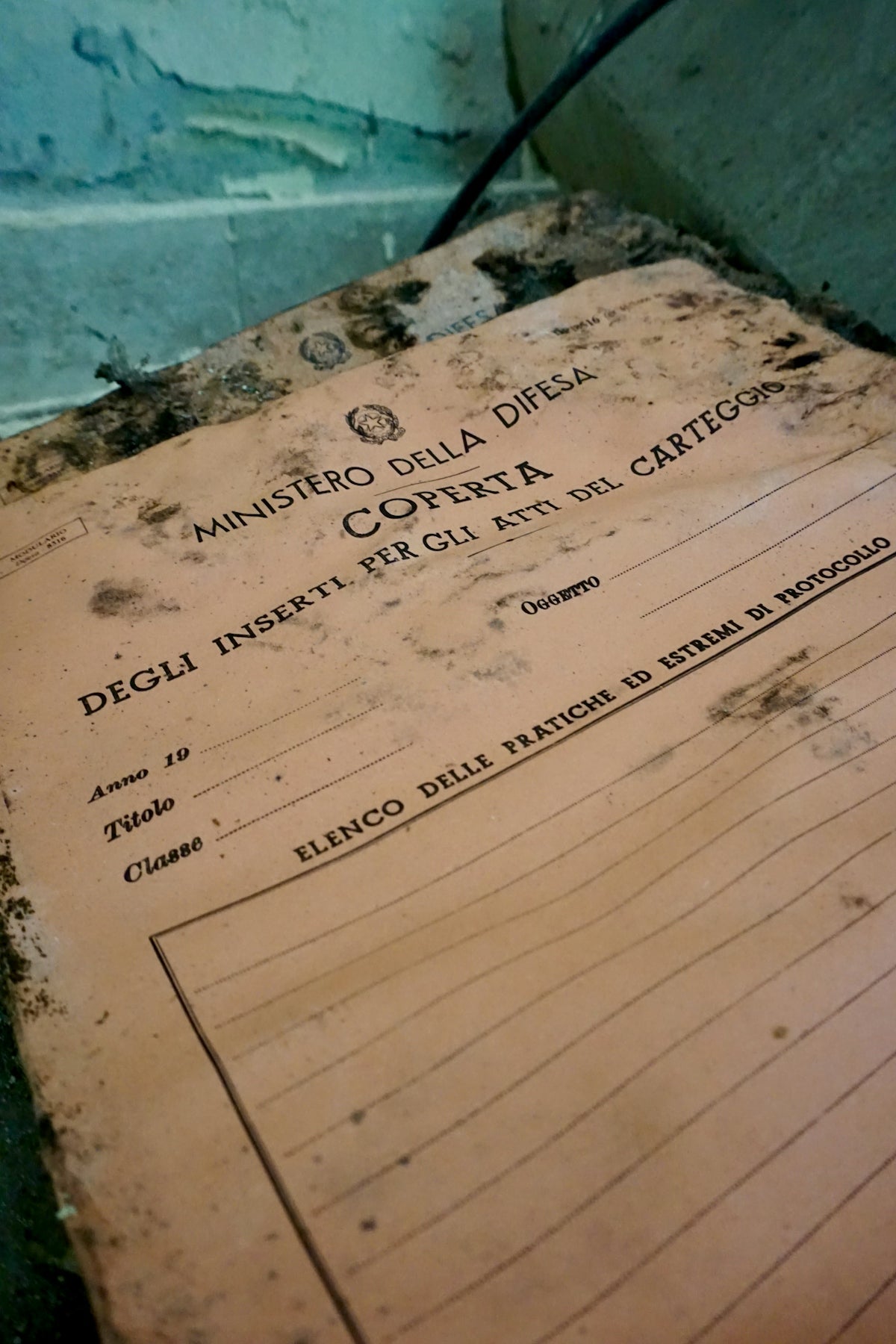 Old, worn document with italian text on a shelf